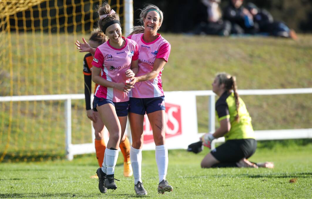 DELIGHT: Chloe Middleton (left) celebrates with a Stingrays teammate after kicking a goal at JJ Kelly Park last year. Picture: Adam McLean