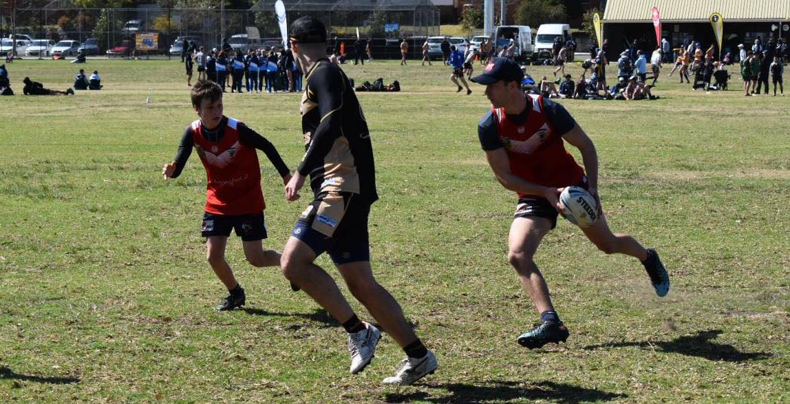 ON THE RUN: Devils player Cody Hutchison passes the ball to a team mate.