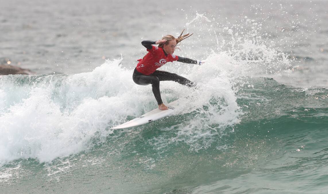 ON A HIGH: Shell Cove surfer Oceanna Rogers in action at Woonona Beach on Wednesday. Picture: Sylvia Liber