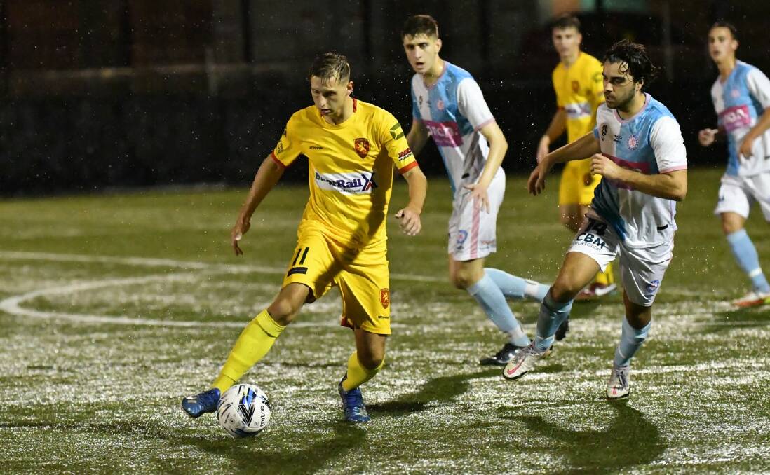 MOVING FORWARD: Wollongong United's Mason Versi controls possession against Dunbar Rovers on Wednesday night. Picture: Richie Wagner
