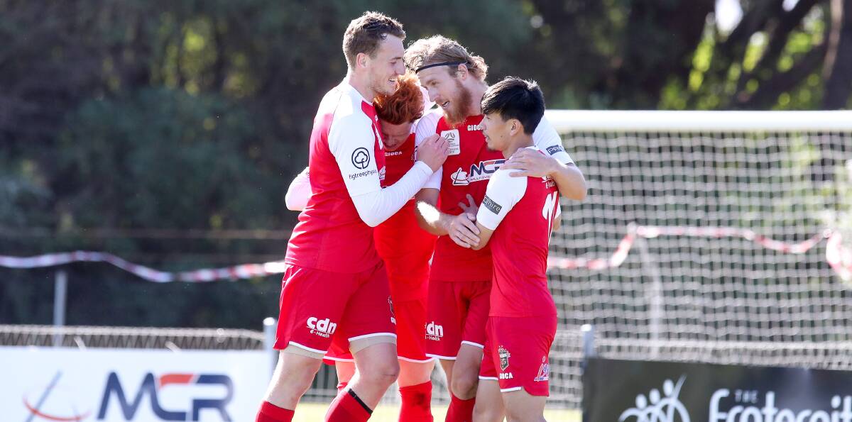 ON TARGET: Josh Bingham (centre) celebrates with his Wolves teammates after scoring a goal on Sunday at Albert Butler Oval. Picture: Adam McLean