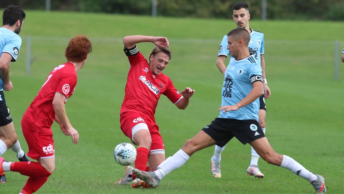 Wolves captain Lachlan Scott (left) competes for the ball with a Sharks opponent. Picture: Sylvia Liber