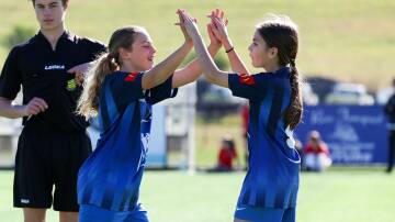 Two Bulli players high-five after scoring a goal during last year's Mini World Cup at Ian McLennan Park. Picture by Adam McLean