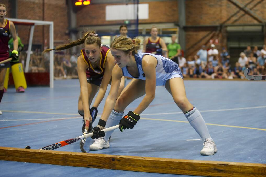 Wollongong's Brooke Welsh (left), representing NSW, works hard to retain ball possession in Thursday's decider. Picture: Anna Warr