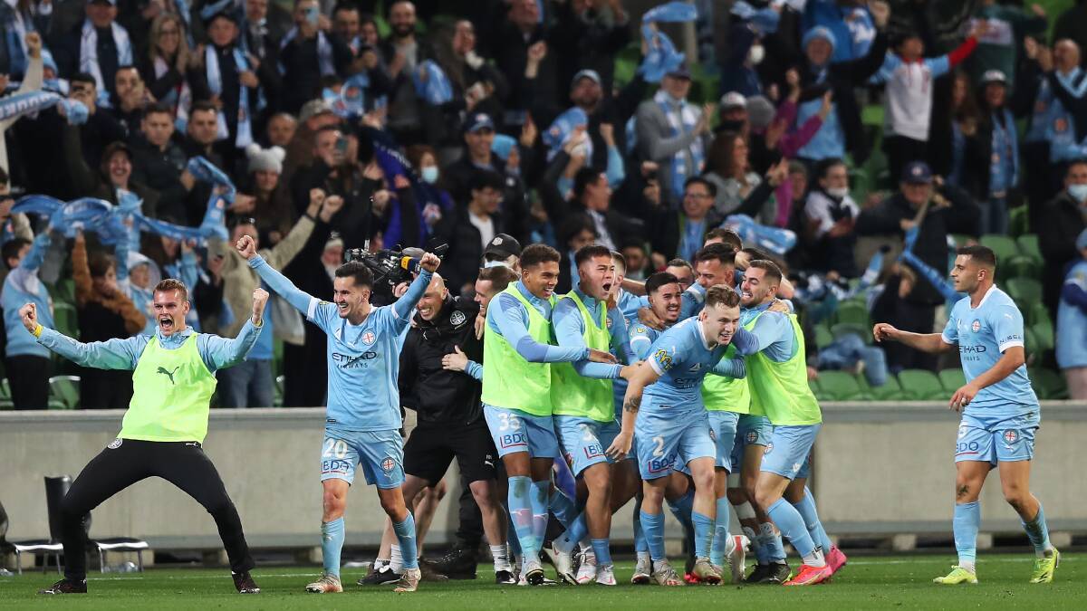 Melbourne City's Scott Galloway celebrates with team mates after scoring their third goal during the A-League grand final against Sydney FC on Sunday. Picture: Graham Denholm/Getty Images