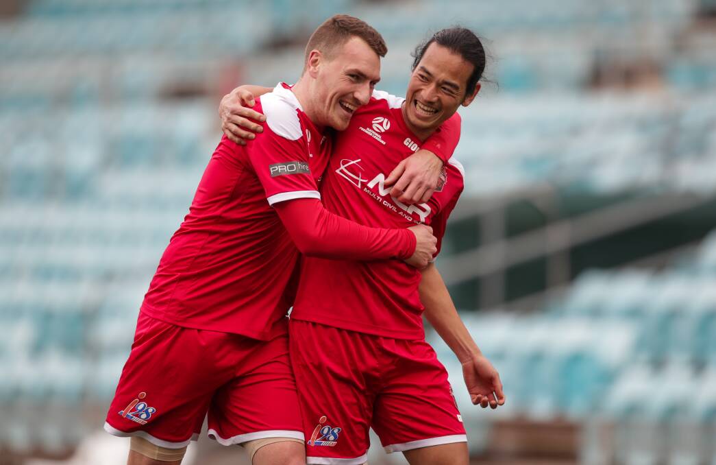 Banri Kanaizumi (right) celebrates a goal with a Wollongong Wolves teammate earlier this year. Picture by Adam McLean