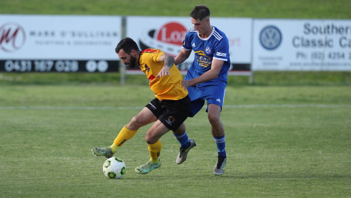 Bulli's Logan Mathie (right) battles with Coniston opponent Samuel Matthews for possession on Saturday. Picture by Robert Peet