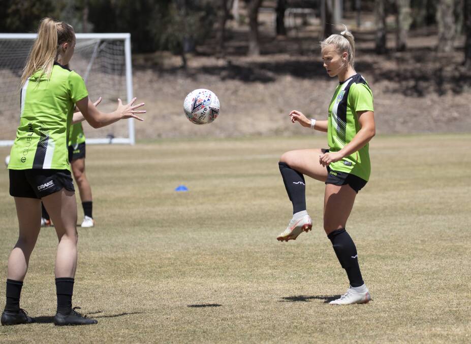 Lauren Keir (right) runs through a training drill with a Canberra United teammate. Picture: Sitthixay Ditthavong 