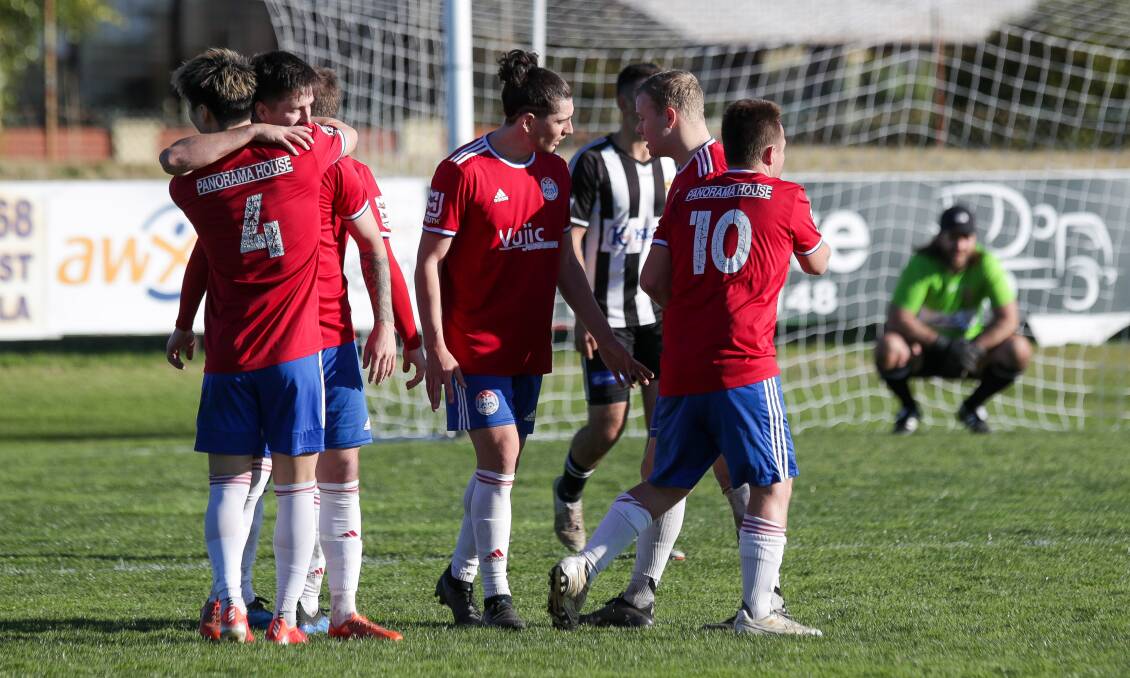 ON TARGET: Cameron Morgan (second from left) celebrates with his White Eagles teammate after scoring a goal on Sunday. Picture: Adam McLean