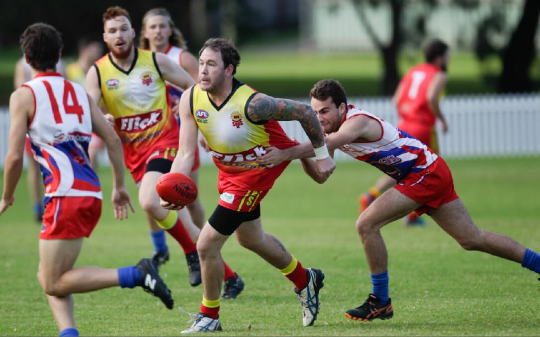 ON THE MOVE: Shellharbour veteran Mark O'Rouke prepares to handball to a Suns teammate during a game against Wollongong Bulldogs. Picture: Georgia Matts