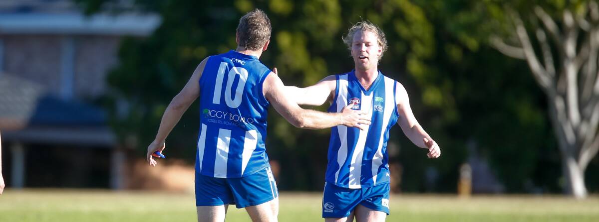 DELIGHT: Two Figtree players celebrate after kicking a goal against Northern Districts on Saturday. Picture: Anna Warr