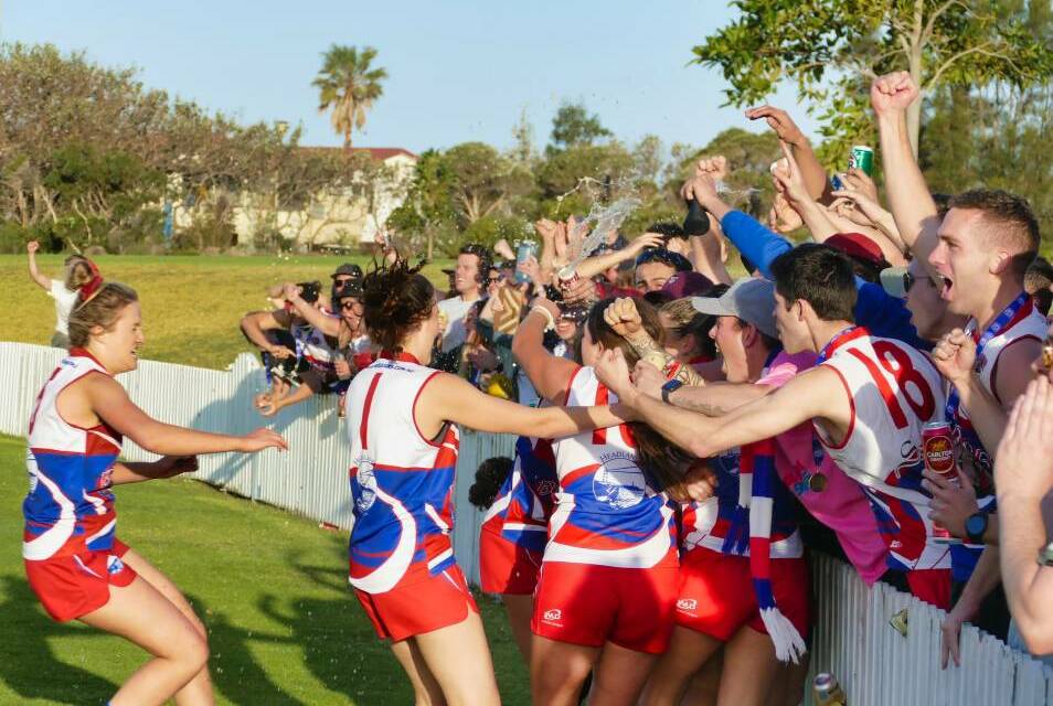 Bulldogs women's players and supporters embrace after Wollongong won last year's title. The club's 2020 season opener was called off due to precautionary reasons over a COVID-19 scare. Picture: Dave Johnson/AFL South Coast