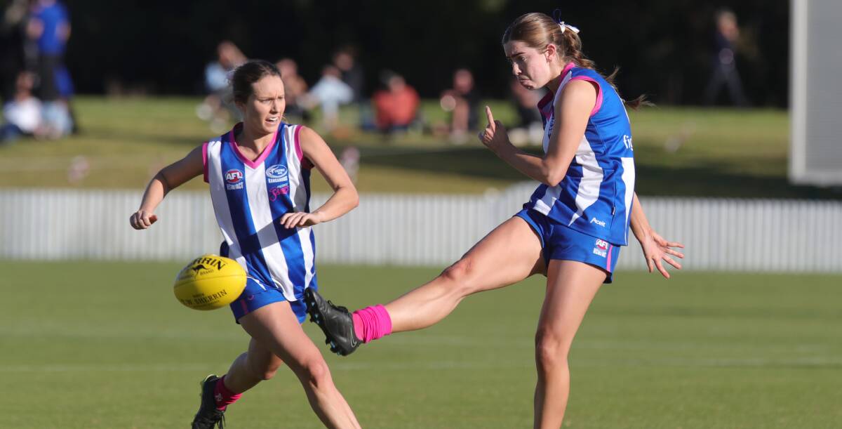 Saints player Demi Arthur (right) boots the ball down field during last year's Women's Premier Division grand final. Picture by Anna Warr