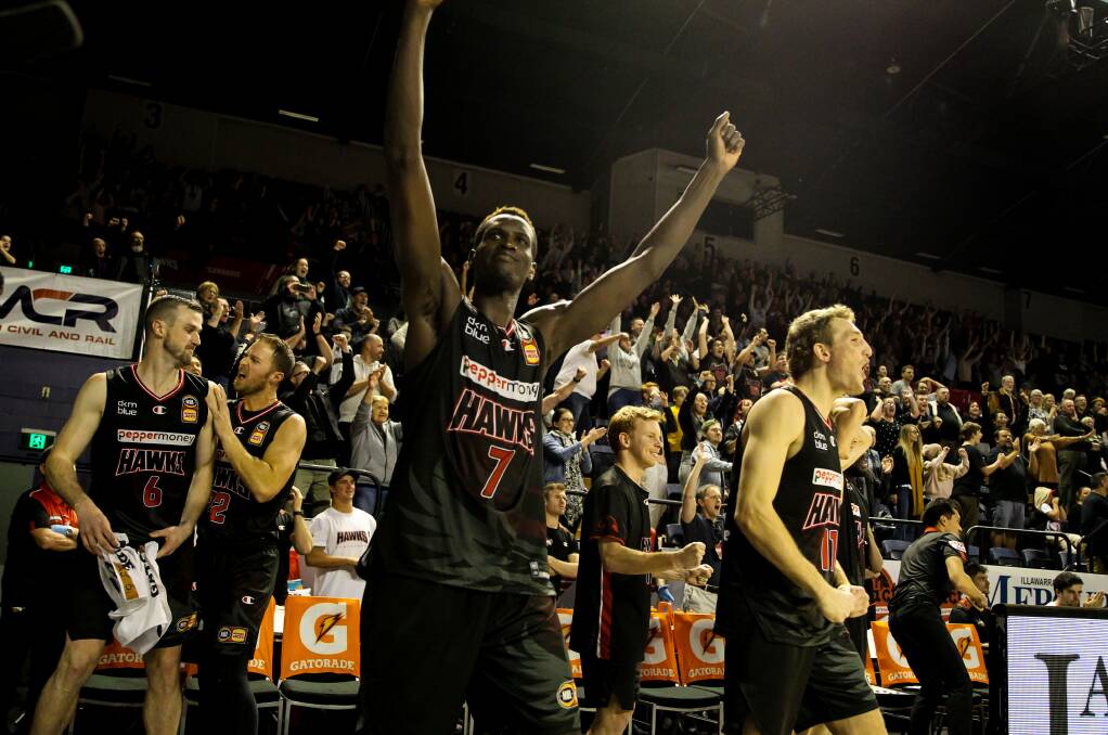 Deng Deng - and Illawarra fans and players - celebrate after the Hawks beat Perth at the WEC last week. Picture: Adam McLean