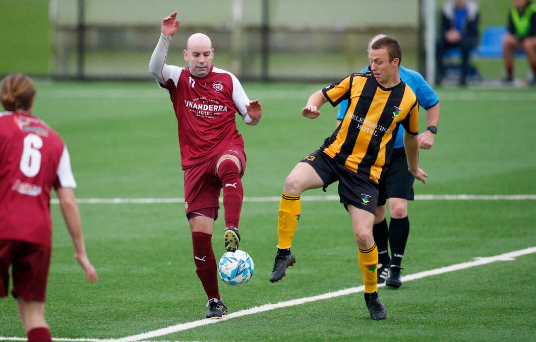 Helensburgh's Charlie Jones (right) competes for the ball against a Hearts opponent on Saturday. Picture by Anna Warr
