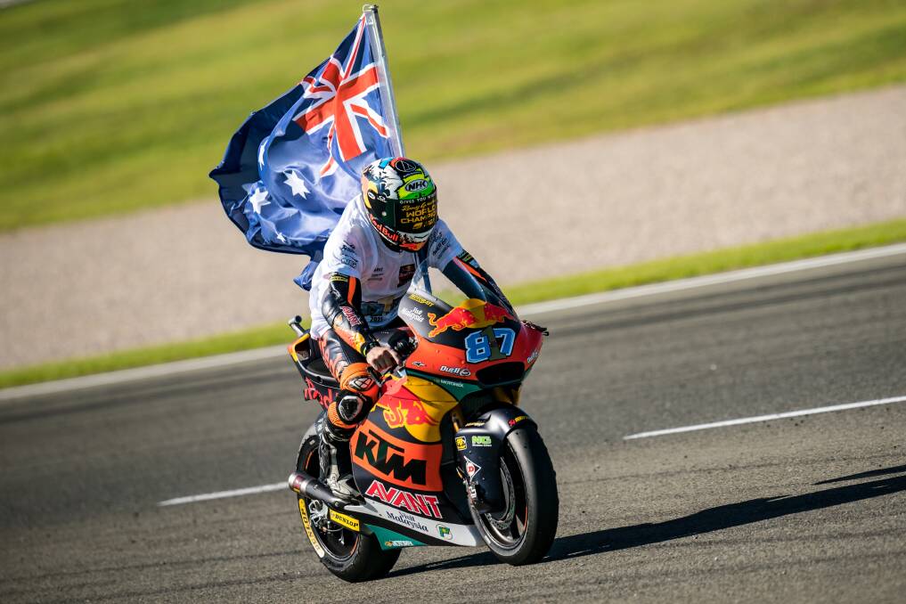 DELIGHT: Moto2 rider Remy Gardner rides with the Australian flag after he won the championship in Valencia, Spain on Sunday. Picture: Steve Wobser/Getty Images
