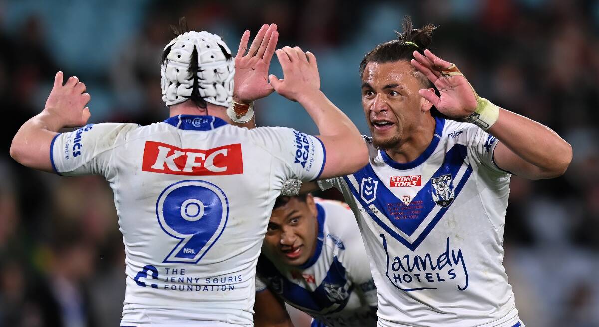 Raymond Faitala-Mariner (right) high-fives a Bulldogs teammate during a game in 2023 against the Rabbitohs at Accor Stadium. Picture by Izhar Khan/Getty Images
