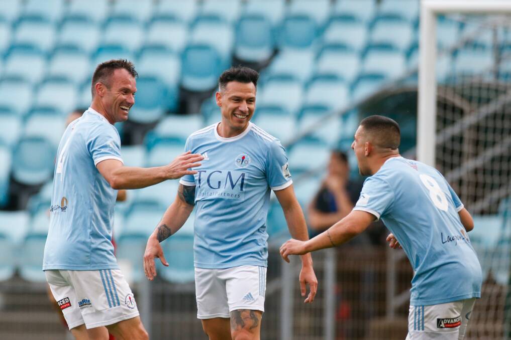 Wollongong Olympic captain Chris Price (left) celebrates with teammates after scoring in last year's Premier League grand final at WIN Stadium. Picture by Anna Warr