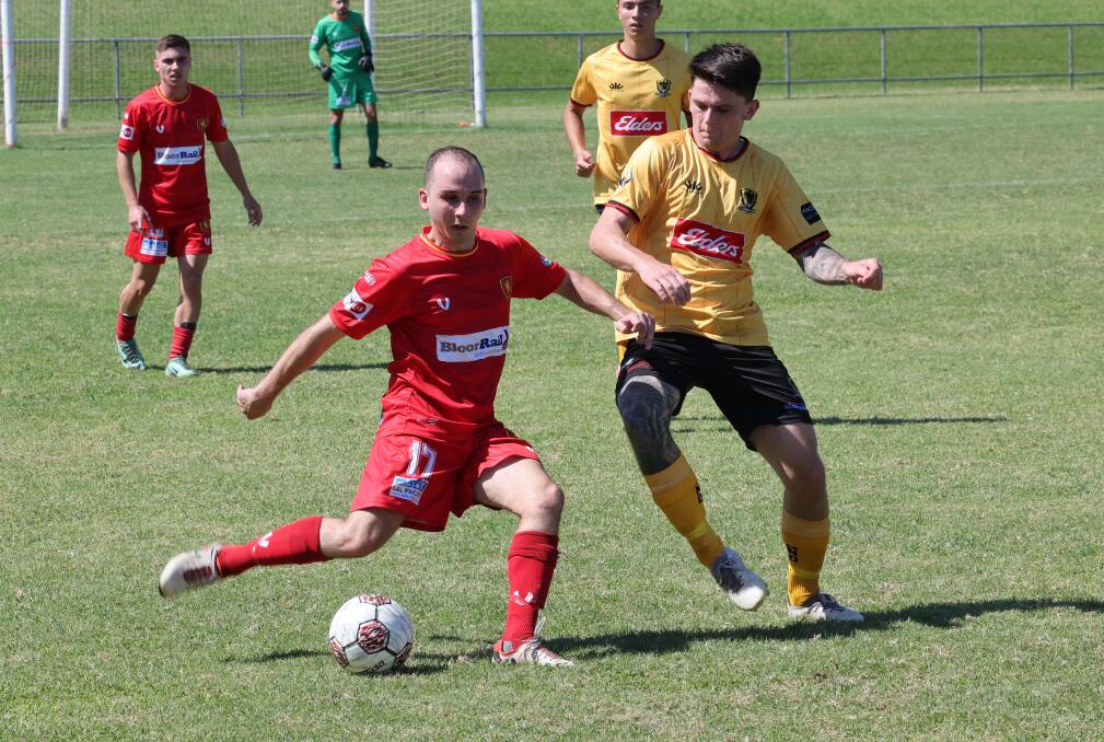 Wollongong United midfielder Jason Zufic prepares to boot the ball down field against Coniston last Saturday. Picture by Robert Peet