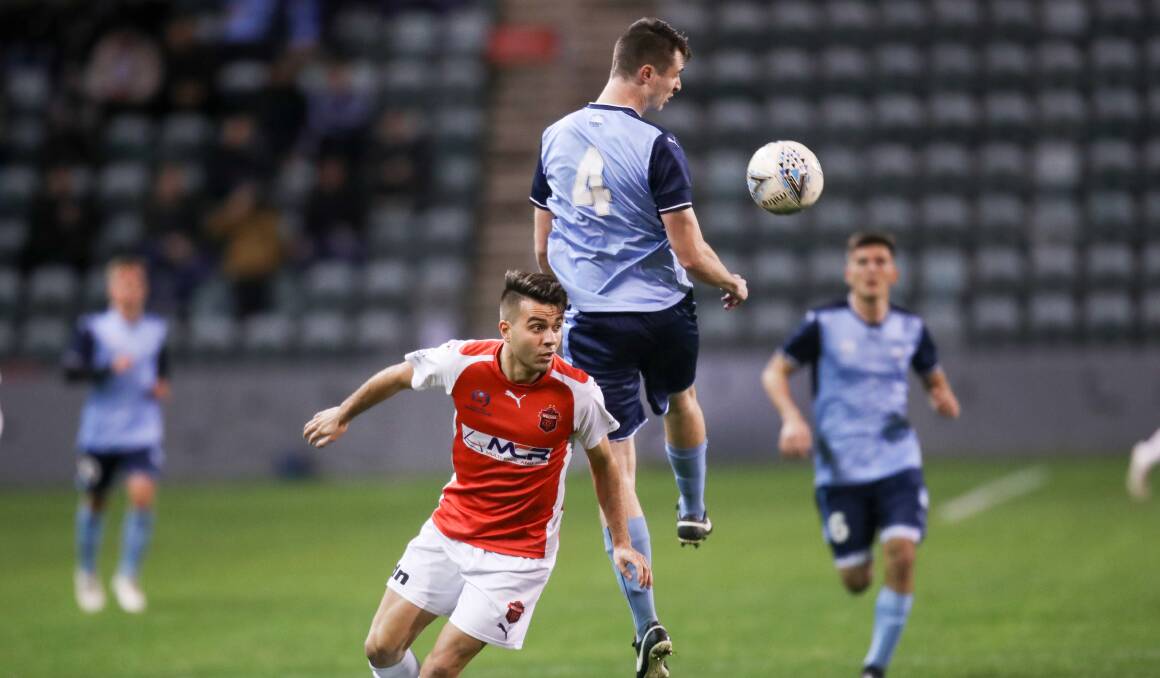 LOOKING AHEAD: Wolves player Peter Simonoski challenges Sydney FC Academy's Liam McGing for the ball at WIN Stadium in 2018. Picture: Adam McLean