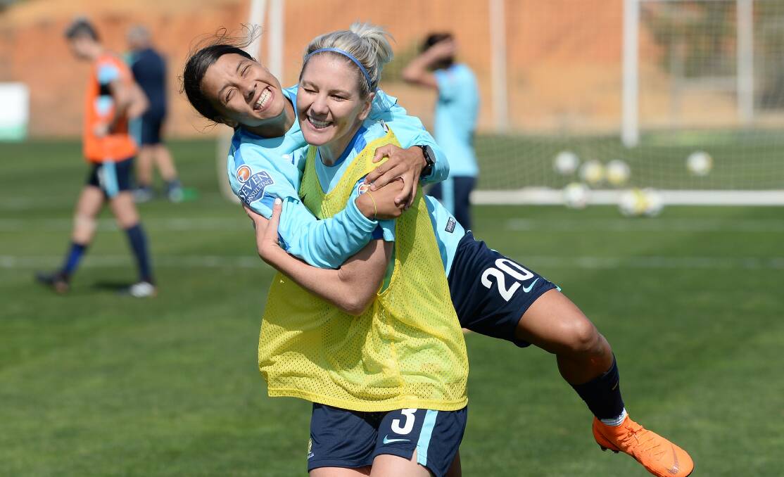 HAPPY DAYS: Caitlin Cooper shares a joke with Matildas teammate Sam Kerr during a training camp in 2018. Picture: Octavio Passos/Getty Images