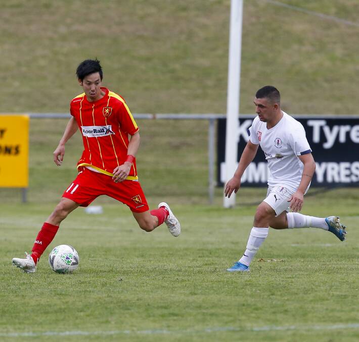 RIVALS: Wollongong United player Kawasakiya Hikaru (left) controls possession. The Sharks will tackle United this Sunday. Picture: Anna Warr