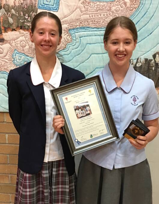 Jacinta and Sarah Cliff receive the Wollongong Diocese Sport Award for their efforts in the senior girls triathlon relay championships in 2019. Picture: Vanessa Cliff