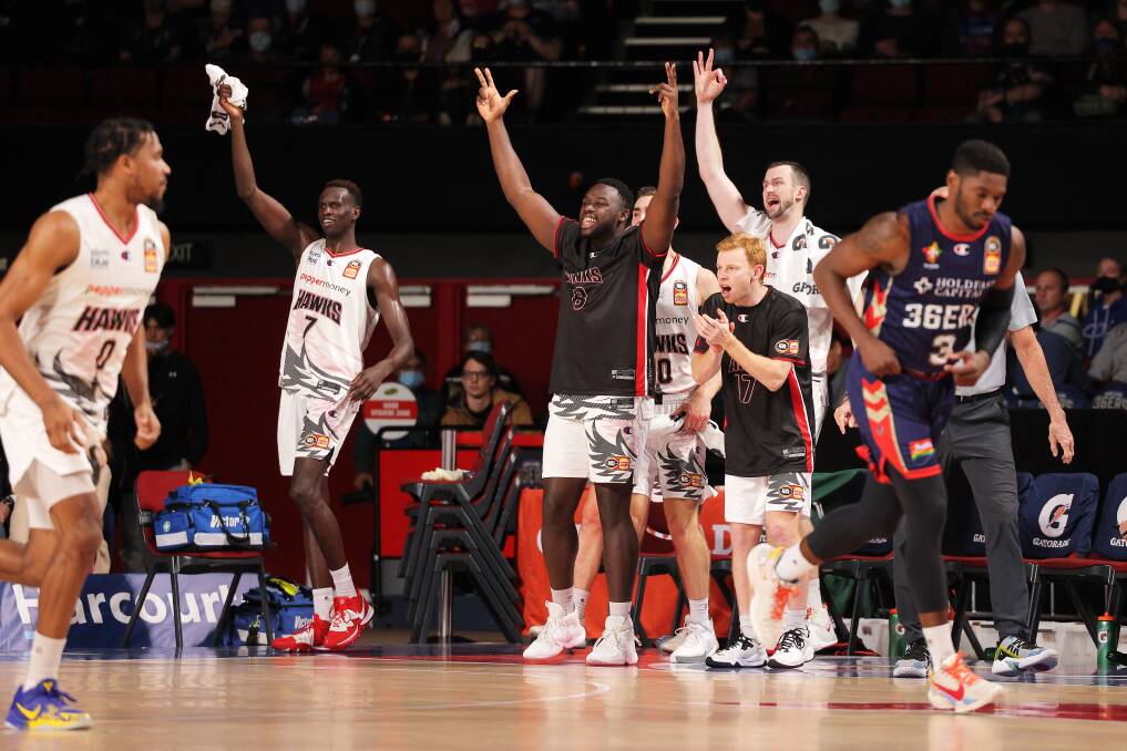Hawks players celebrate during Friday night's clash with the 36ers in Adelaide. Picture: Daniel Kalisz/Getty Images