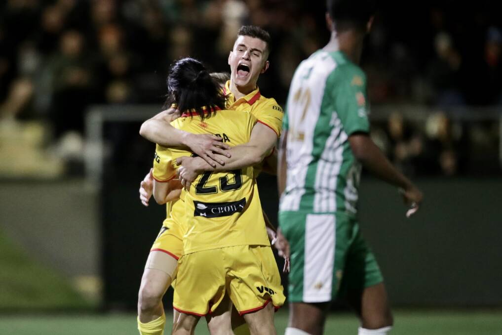 DELIGHT: Bailey Babarovski celebrates with Wollongong United teammate Mitsuo Yamada after Yamada scored the opening goal on Wednesday night. Picture: Adam McLean