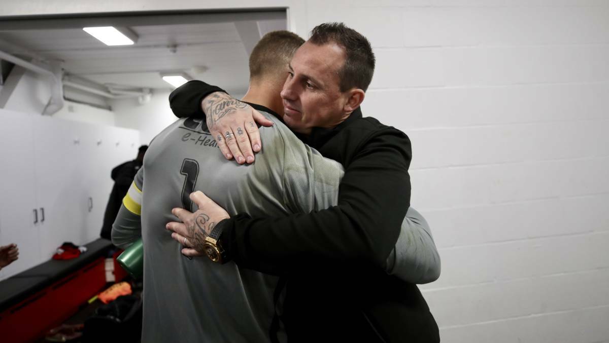 Emotional: Wolves goalkeeper Hayden Durose hugs his outgoing coach, Luke Wilkshire. Picture: Adam McLean