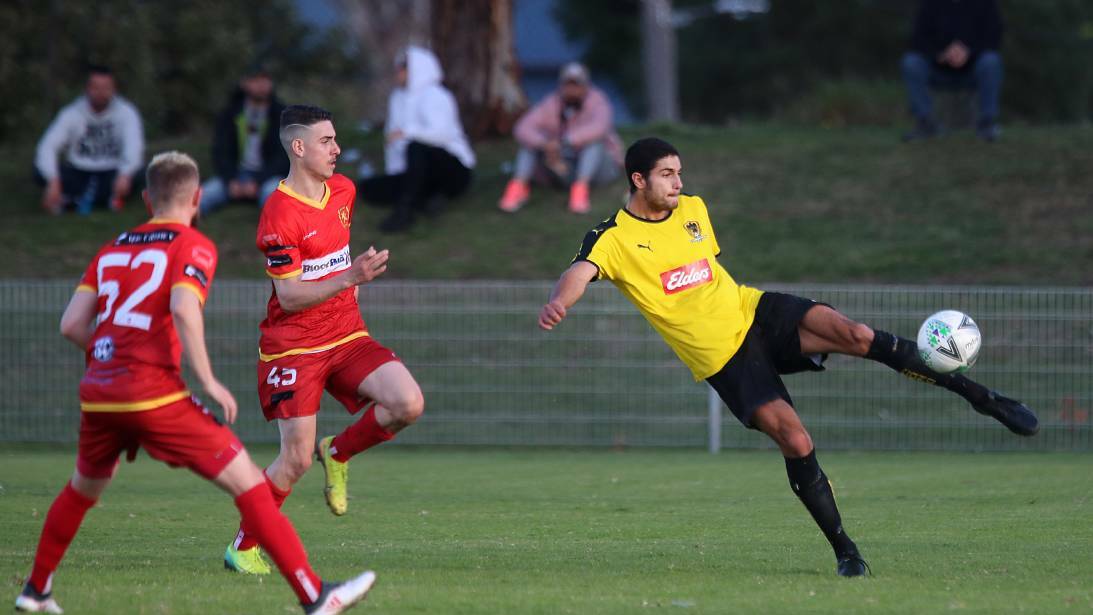 Coniston's Tyren Maclou prepares to boot the ball to a teammate during the Frat Cup final against Wollongong United. Picture: Sylvia Liber