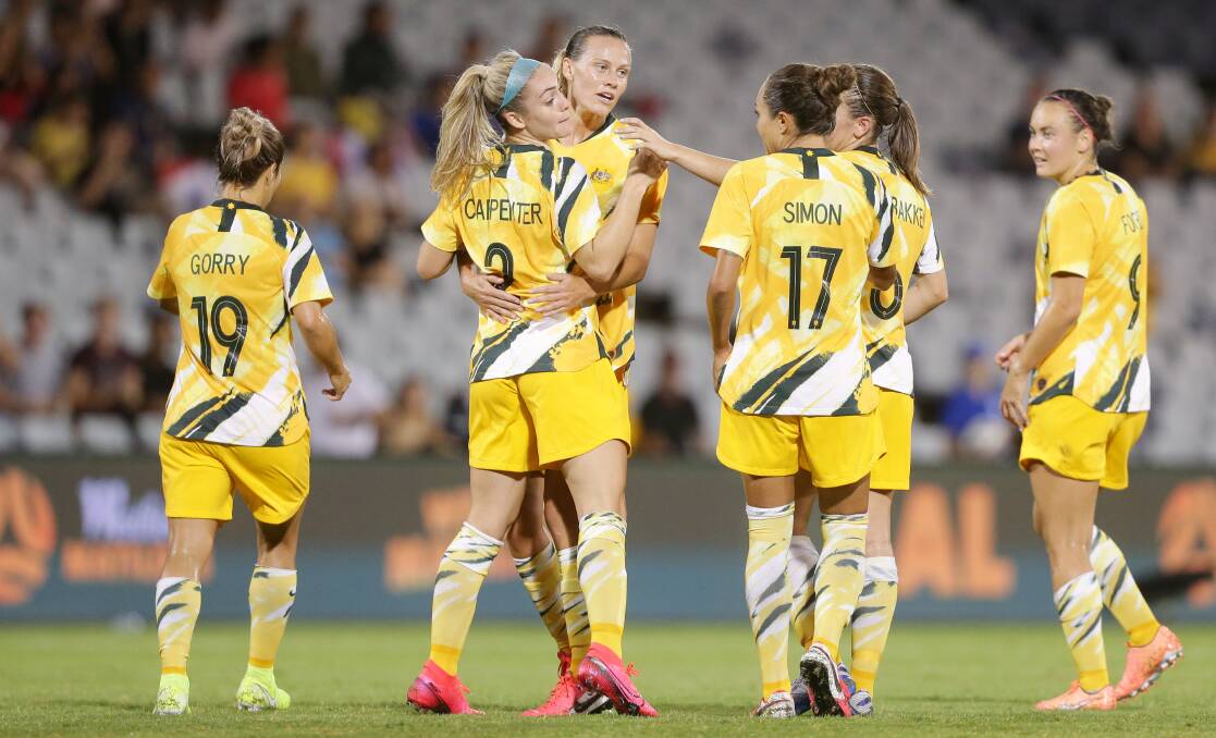INSPIRING: Matildas players Emily van Egmond and Ellie Carpenter embrace after scoring a goal against Thailand in February. Picture: Chris Lane