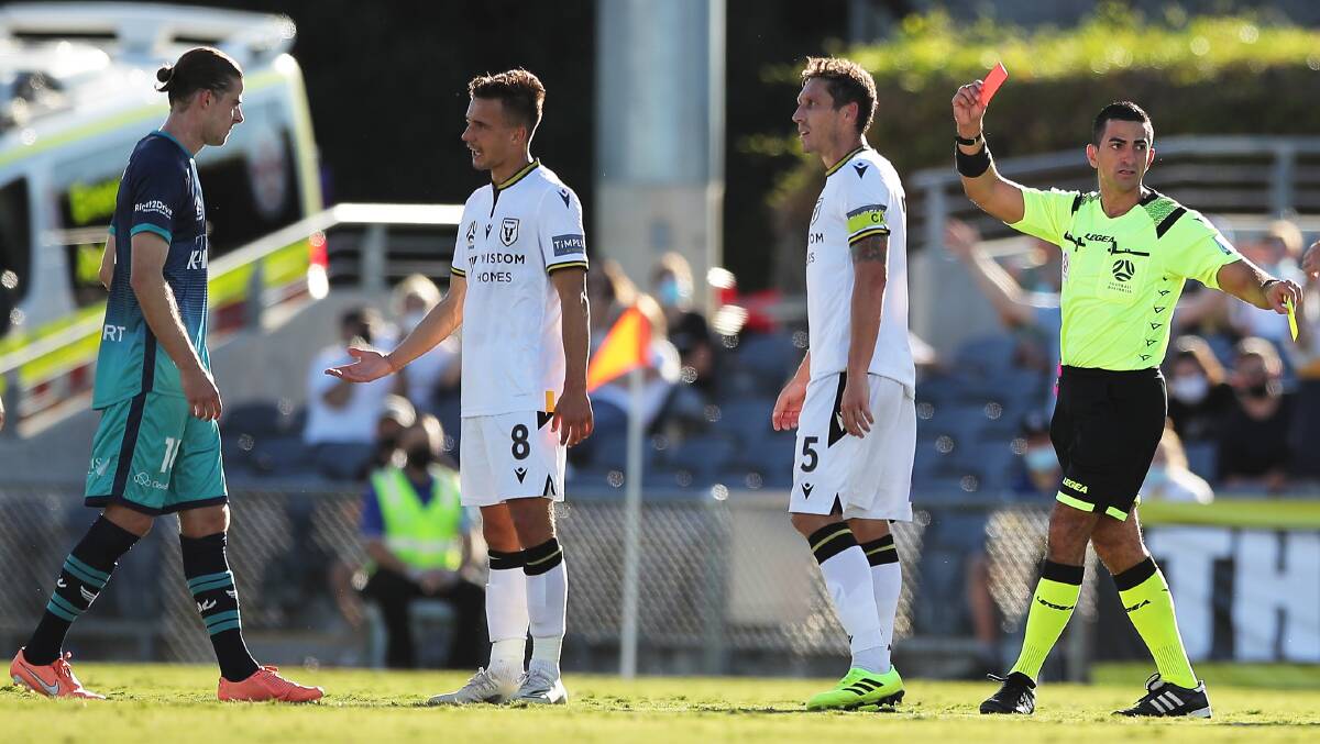 The referee awards a red card to Phoenix midfielder Alex Rufer (left) during Saturday's draw with Macarthur FC at Campbelltown Stadium. Picture: Matt King/Getty Images