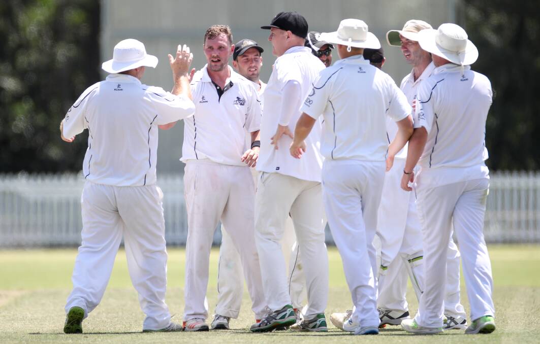 DELIGHTED: Bowler Chris Flanigan (second from left) celebrates with Balgownie team mates after dismissing Uni's Andrew Page on Saturday. Picture: Adam McLean