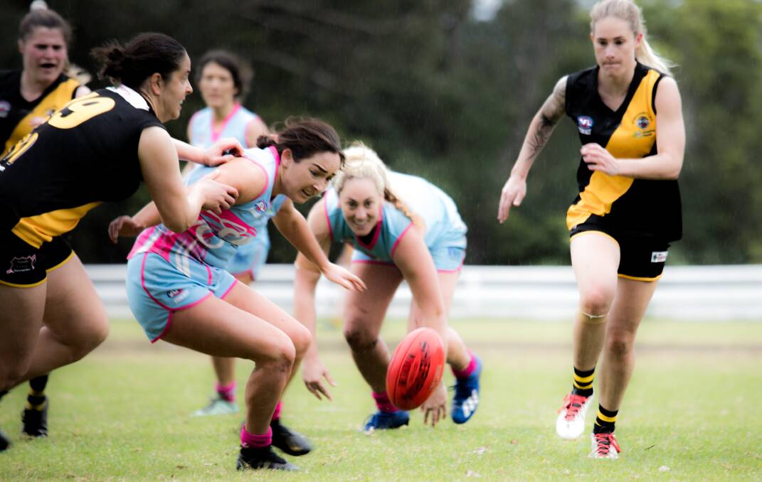 FOCUSED: Saints players Sally O'Donoghue (front) and Caitlin Williams keep their eyes on the ball against Bomaderry last week. Picture: Team Shot Studios