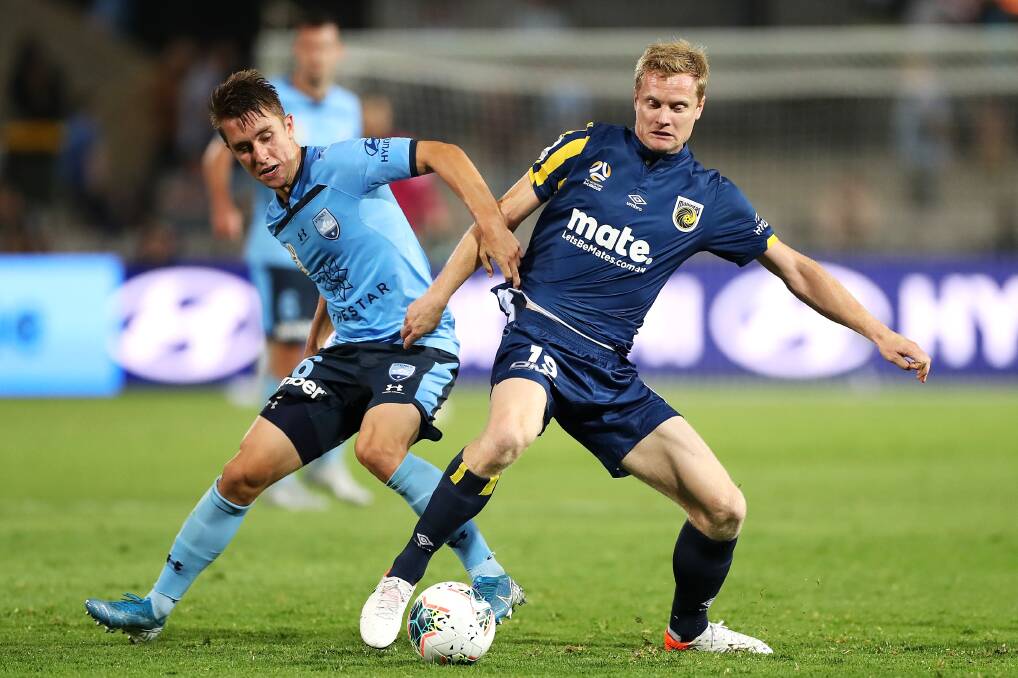 FOCUSED: Sydney FC's Joel King (left) contests possession with Central Coast Mariners veteran Matt Simon earlier this season. Picture: Mark Kolbe/Getty Images