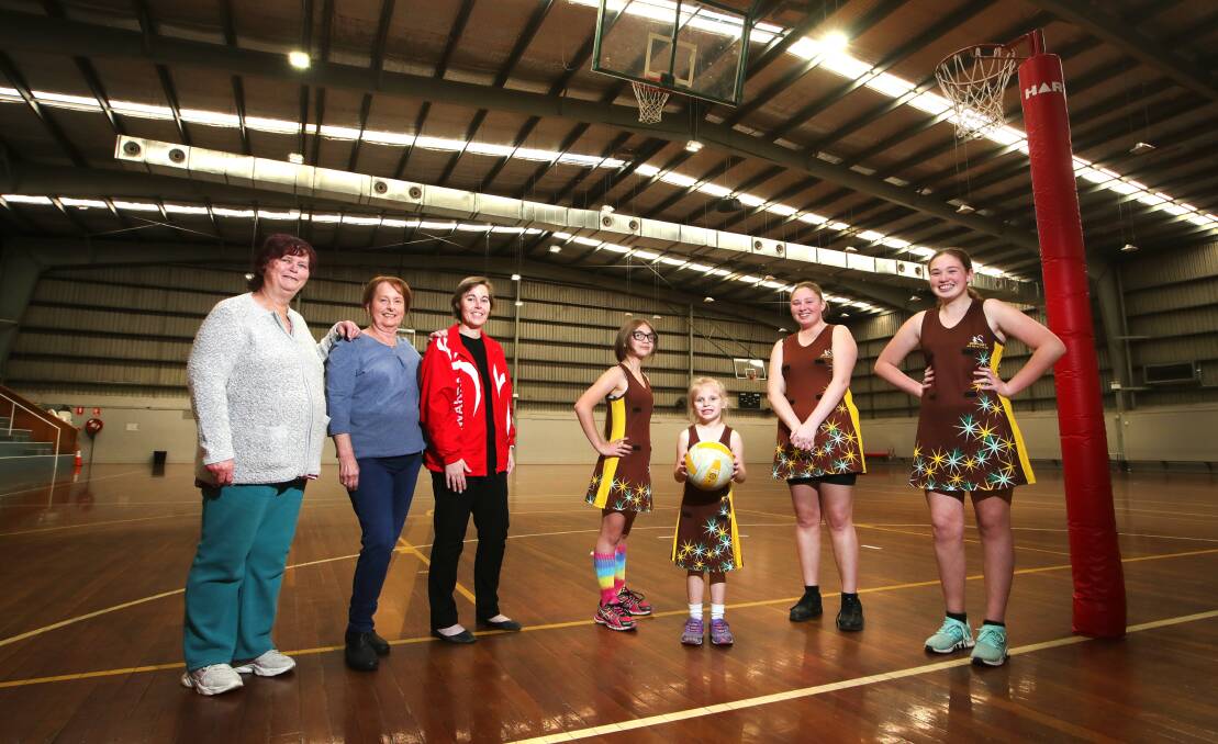 MILESTONE: Illawarra District Netball Association life members Gerry Evry (left) and Dianne Elvy, and association vice-president Vanessa Sturman with netballers Illiana Davies, Allegra Davies, Lily Andrews and Skye Andrews. Picture: Sylvia Liber 