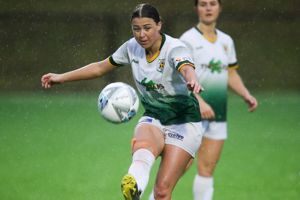 WORKING HARD: Albion Park's Brittany Ring kicks the ball during a women's game in the rain at Ian McLennan Park. Picture: Adam McLean