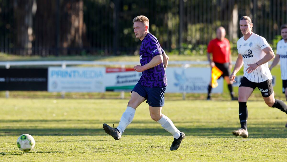 Brendan Wyatt passes the ball while playing for University of Wollongong against Balgownie in August. Picture by Anna Warr