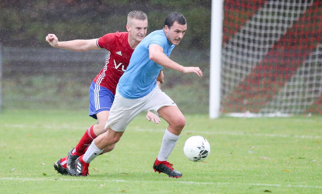 Corrimal player Tim Wylie chases after the ball during a Fraternity Cup game in the rain against Albion Park last March. Picture: Adam McLean