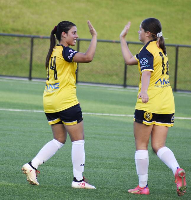 Zinah Hasan high fives a South Coast Flame teammate. Picture: Multicultural Communites Council of Illawarra