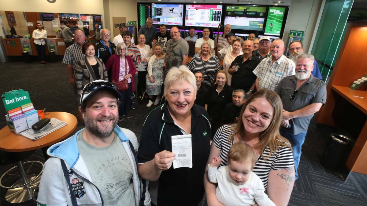 Alan, Kelly and Charlise Montgomery with Shellharbour TAB's Christine Tolhurst (centre) and the punters club. Picture: Robert Peet