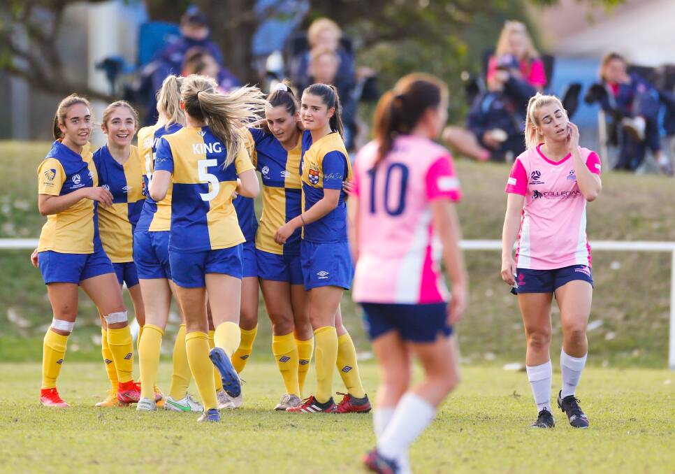 WINNERS: Sydney University players celebrate after scoring their first goal against the Stingrays at JJ Kelly Park on Sunday. Picture: Anna Warr