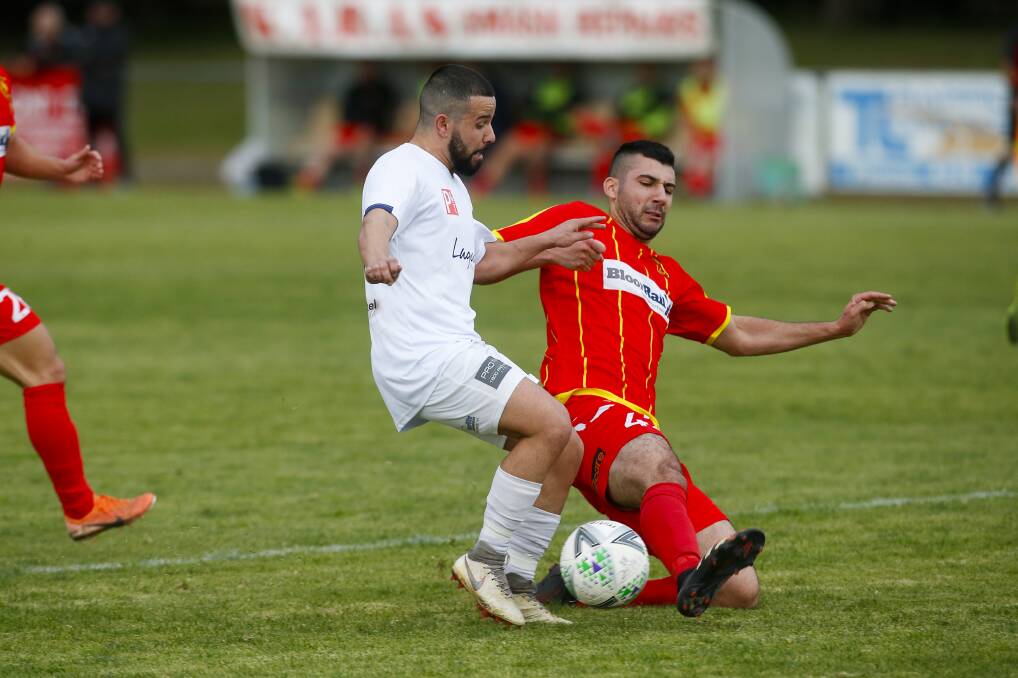 Olympic player Johnny Martinoski and United's Danny Lazarevski battle for possession at Macedonia Park on Saturday. Picture: Anna Warr 
