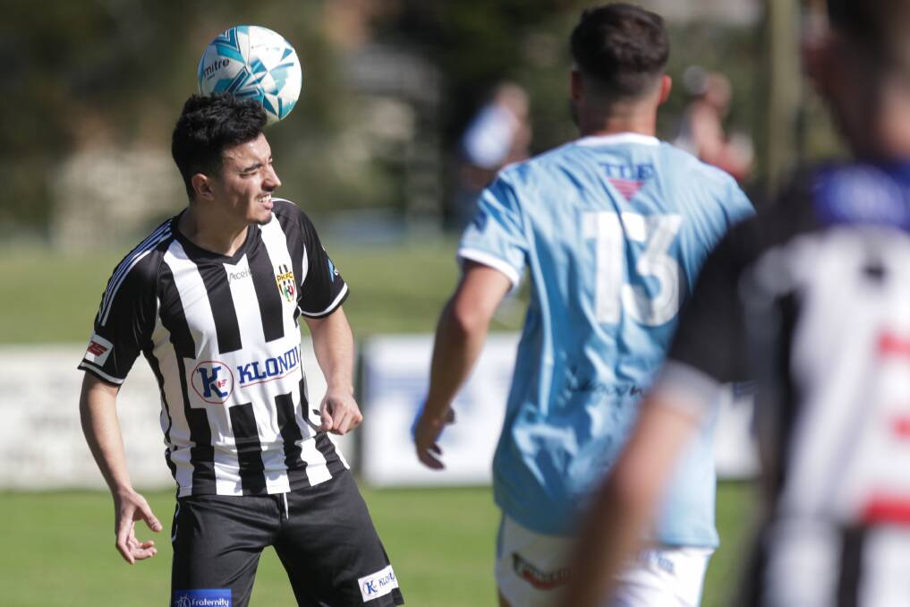 Port Kembla player Daniel Carella heads the ball against Olympic on Friday. Picture: Adam McLean