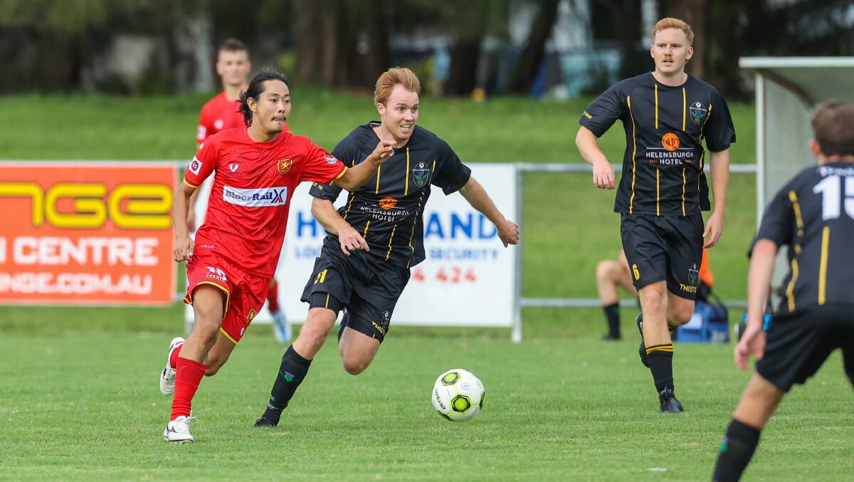 Helensburgh's Liam Unicomb leads his Wollongong United opponent in the race to the ball on Saturday. Picture by Wesley Lonergan