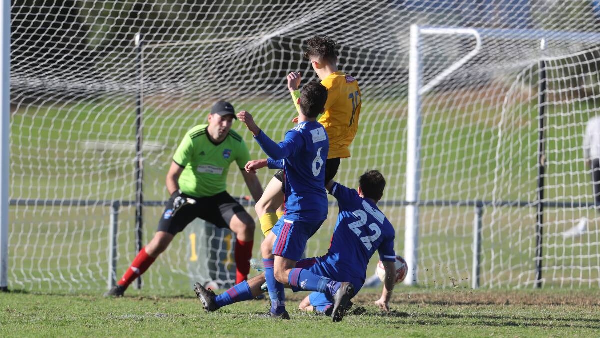 Coniston player Anthony Krsteski scores his side's first goal at Ocean Park on Saturday. Picture: Robert Peet