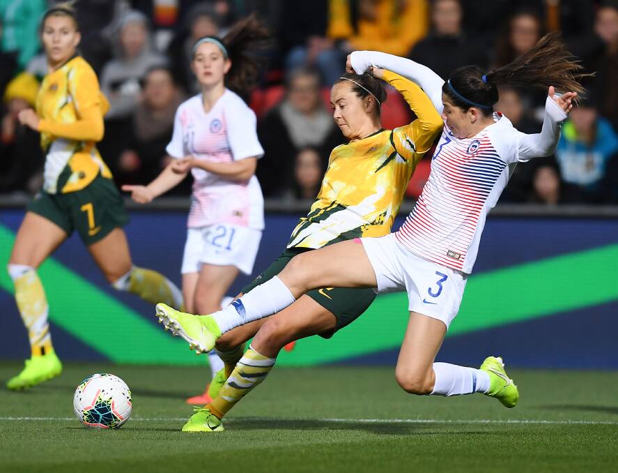 Caitlin Foord is tackled by Chile's Carla Guerreo at Coopers Stadium on Tuesday night. Picture: Mark Brake/Getty Images