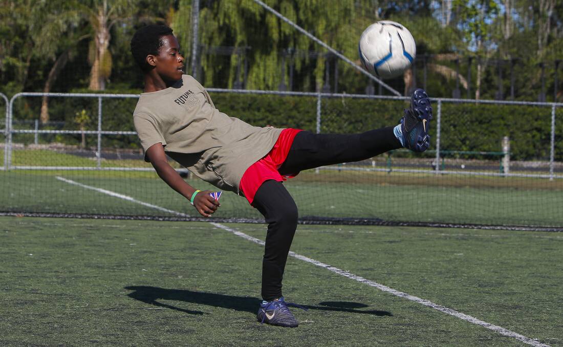 EYES ON THE BALL: Innocent Nzovu, 14, is learning new skills through the Football South Coast's weekly refugee program. Picture: Anna Warr
