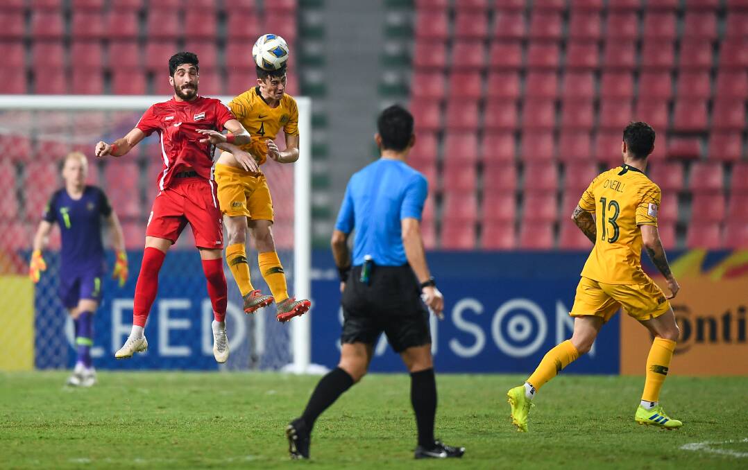 FLYING HIGH: Olyroos defender Dylan Ryan heads the ball away during the AFC Under 23s Championships. Picture: Asian Football Confederation